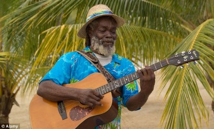 Jamaican man playing guitar