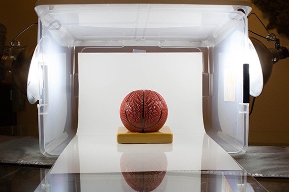 e-commerce photography of basketball inside plastic tub with paper
